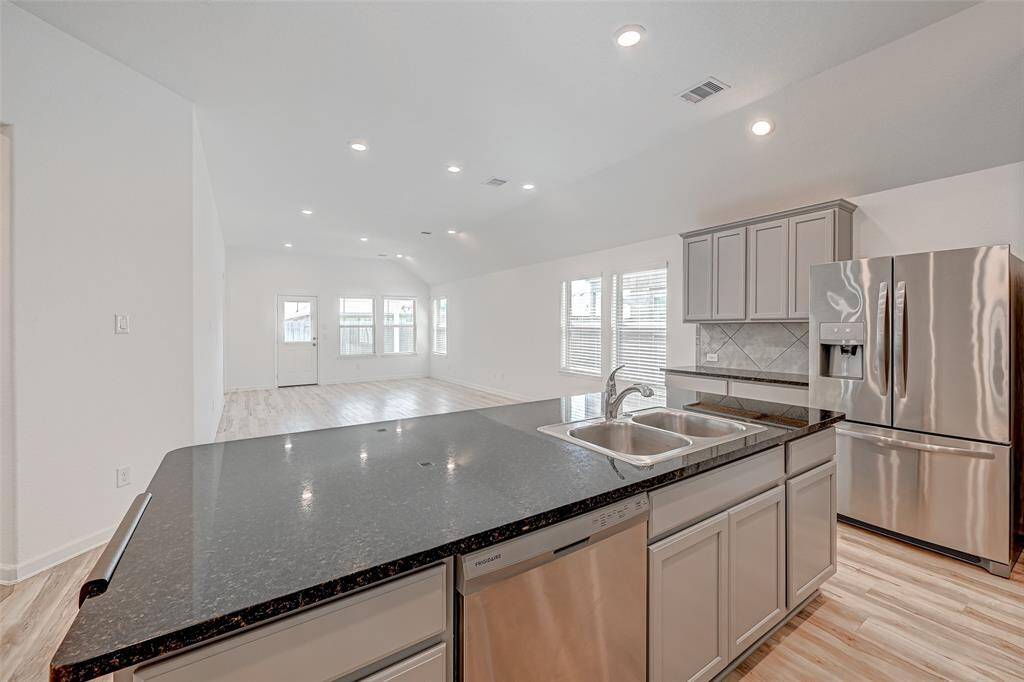 Huge island with sink, dishwasher, and plenty of room for stools.