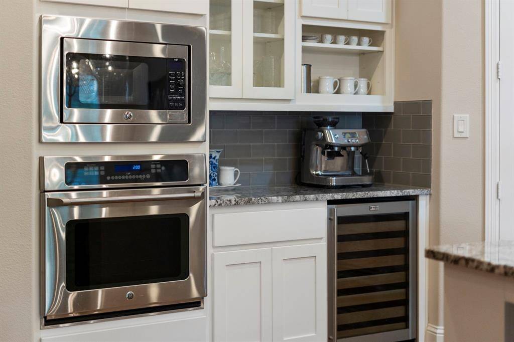 The kitchen is equipped with a built-in stainless steel oven and microwave, offering a modern look while providing efficient, high-performance cooking options.