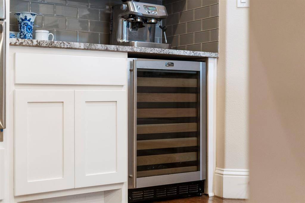 A built-in wine cooler adds both sophistication and convenience to the kitchen, providing an ideal space to store and showcase your favorite wines at the perfect temperature.