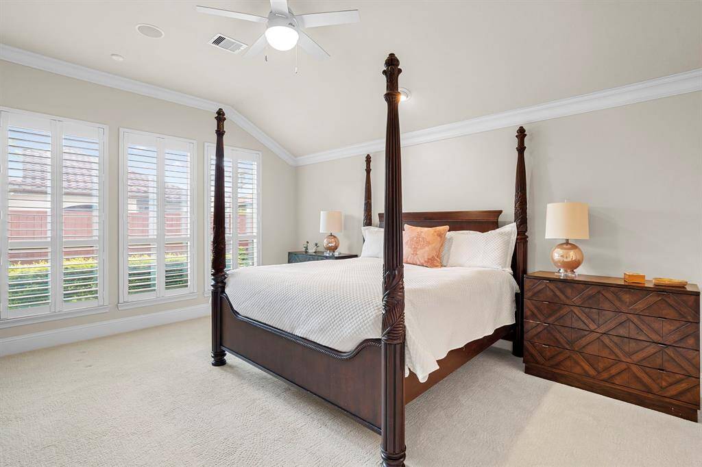 Retreat to the serene primary suite, a true sanctuary with a vaulted ceiling and wall of windows with relaxing views of the private backyard.