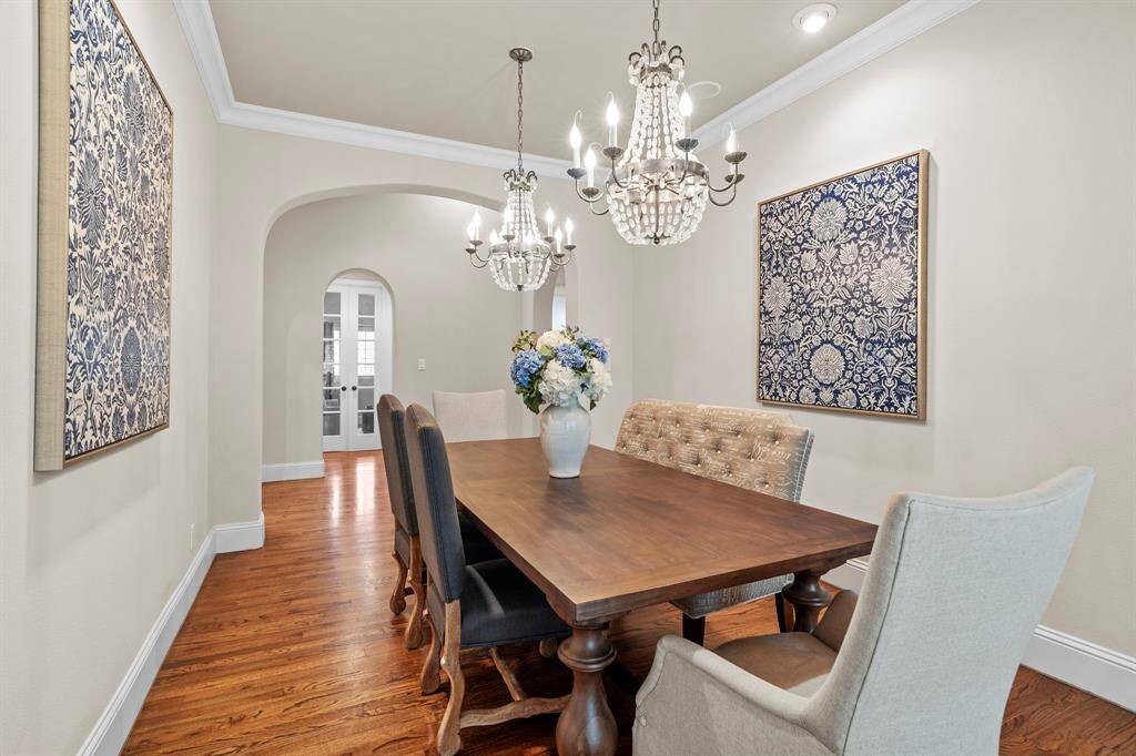 Step inside to a light-filled, open-concept layout featuring rich hardwood floors, graceful archways, and soaring ceilings that create a grand yet inviting ambiance.