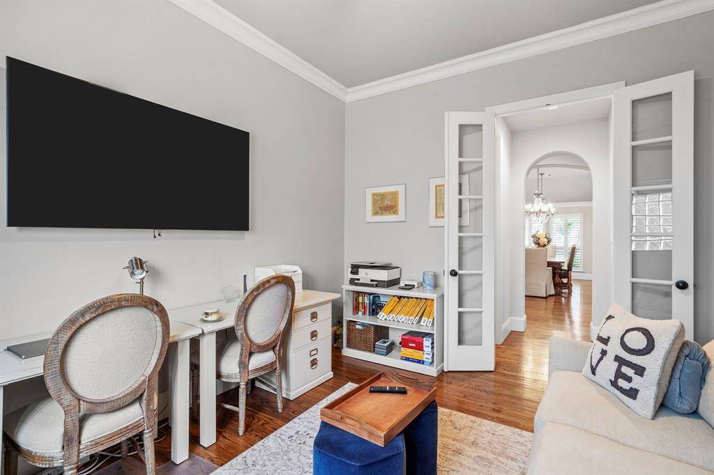 French doors offer both privacy and a sound barrier in the home office, creating a quiet and stylish space ideal for focused work or study.