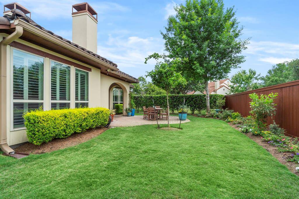 A grassy area in the backyard provides a versatile space for recreation, relaxation, and play—ideal for children, pets, or outdoor entertaining—while adding natural beauty and softness to the landscape.
