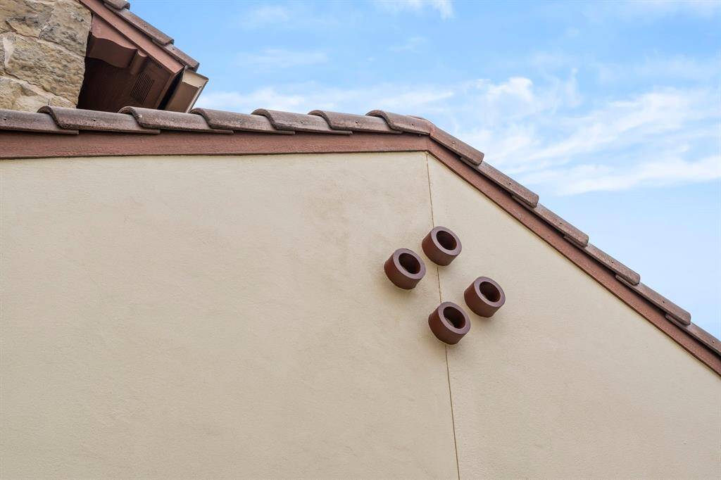 This exquisite brick, stone, and stucco residence with terra-cotta tile roof seamlessly blends timeless Spanish architecture with sleek, modern touches, offering a fresh, sophisticated aesthetic in one of the area’s most desirable neighborhoods.