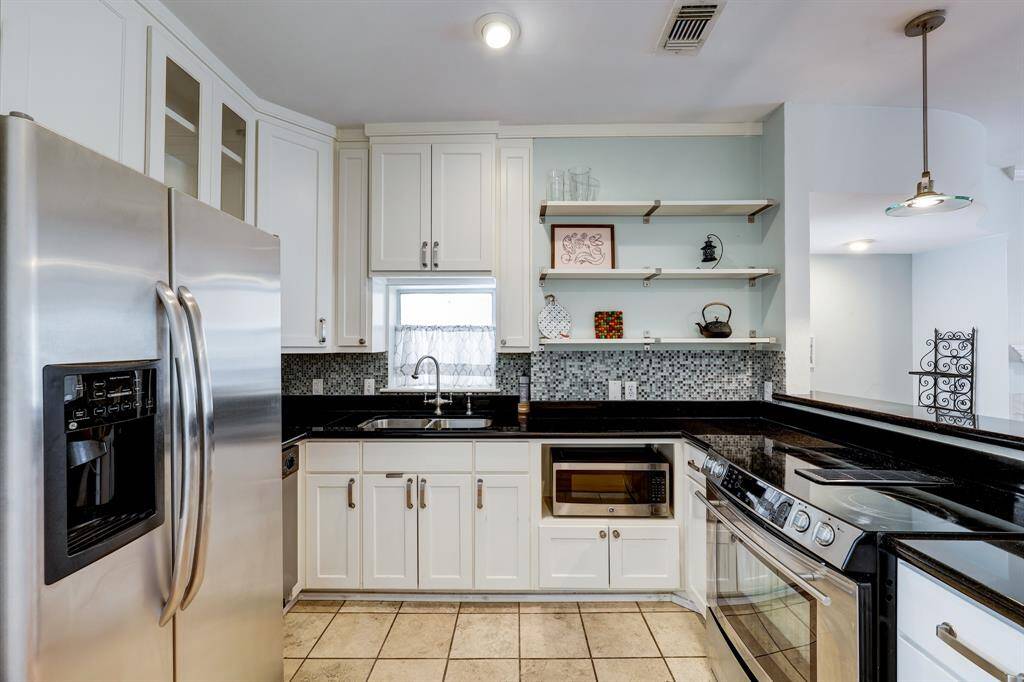Stylish cabinets and black galaxy granite counter tops.