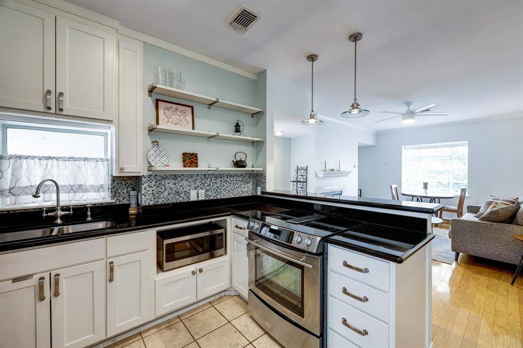 Stainless appliances, including stove, microwave, dishwasher, and fridge.