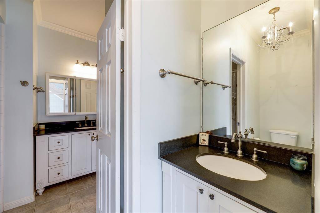Powder room with sink and toilet can be closed off from main bath area for privacy.
