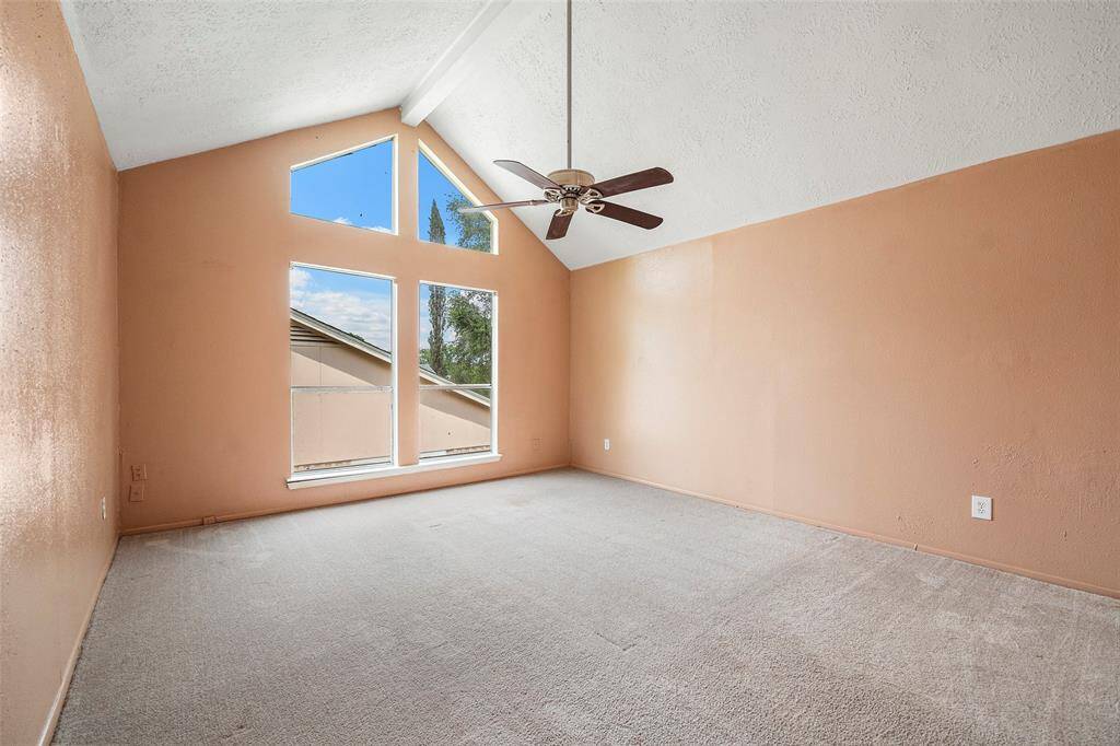 The second story primary bedroom is a light-filled space with the large windows allowing natural light to fill the space.