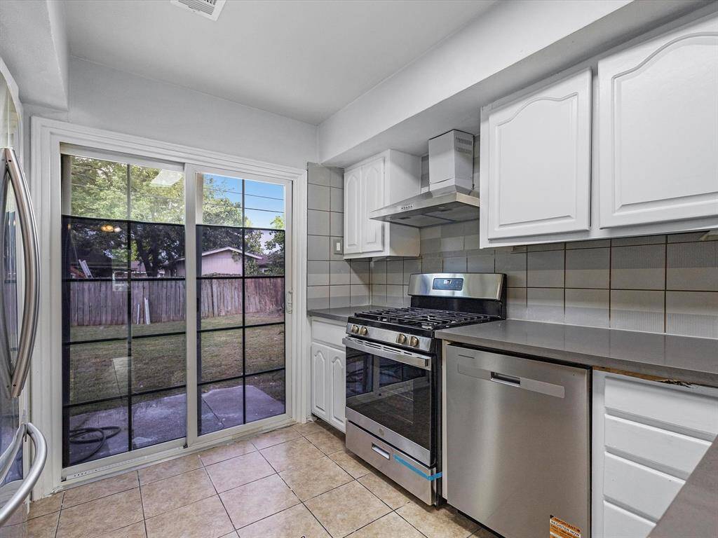 Kitchen with gas stove and sliding door to back yard.