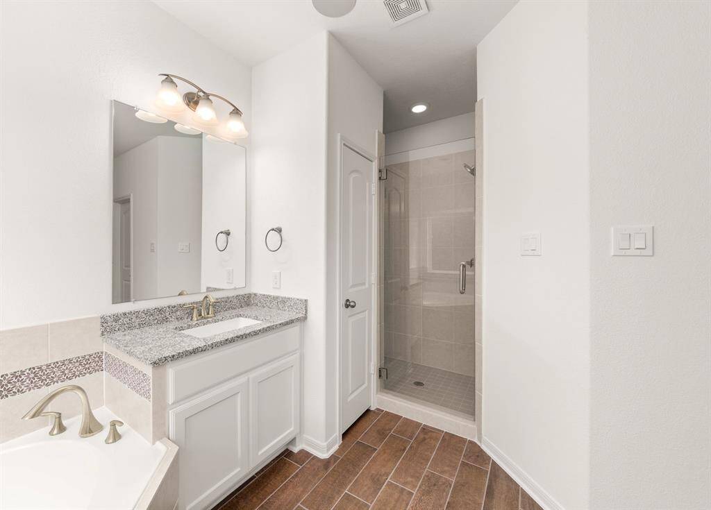 Experience luxury in the master suite with dual vanities and a walk-in shower