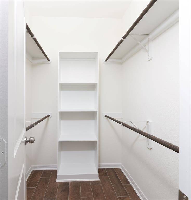 Spacious walk-in closet with custom built-ins