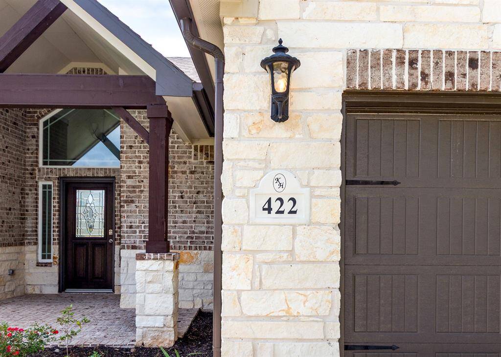 Charming covered front porch, ideal for relaxing with plants or cozy seating