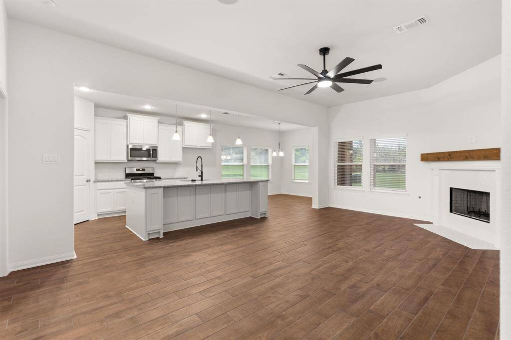 Experience seamless living with a spacious open floor plan connecting the kitchen, living, and dining areas