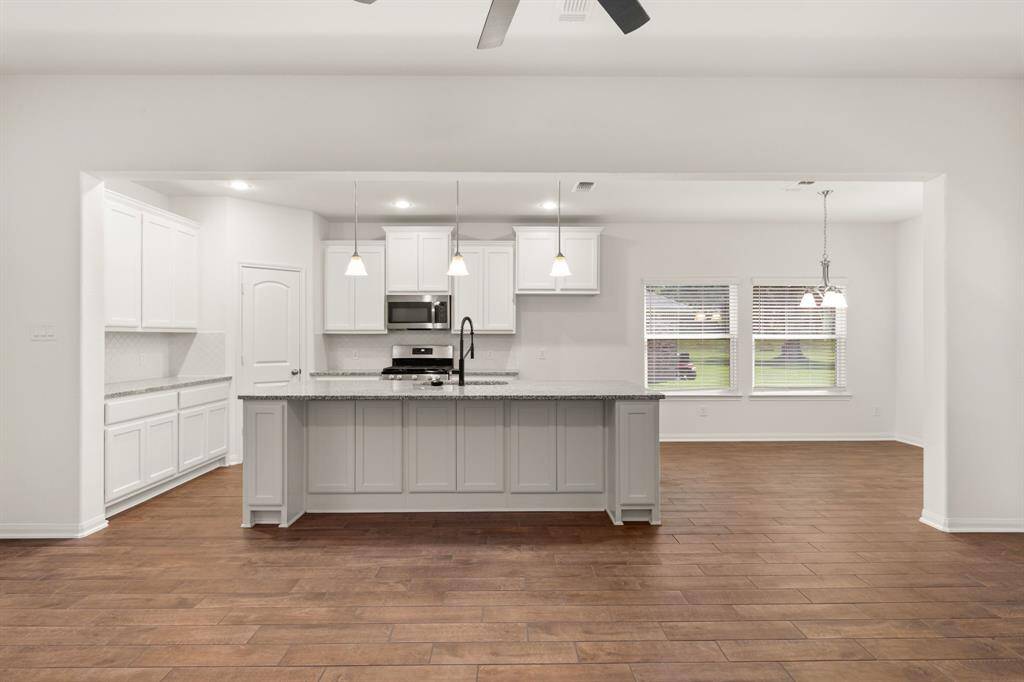 The kitchen island offers additional seating, making it perfect for entertaining guests and hosting gatherings