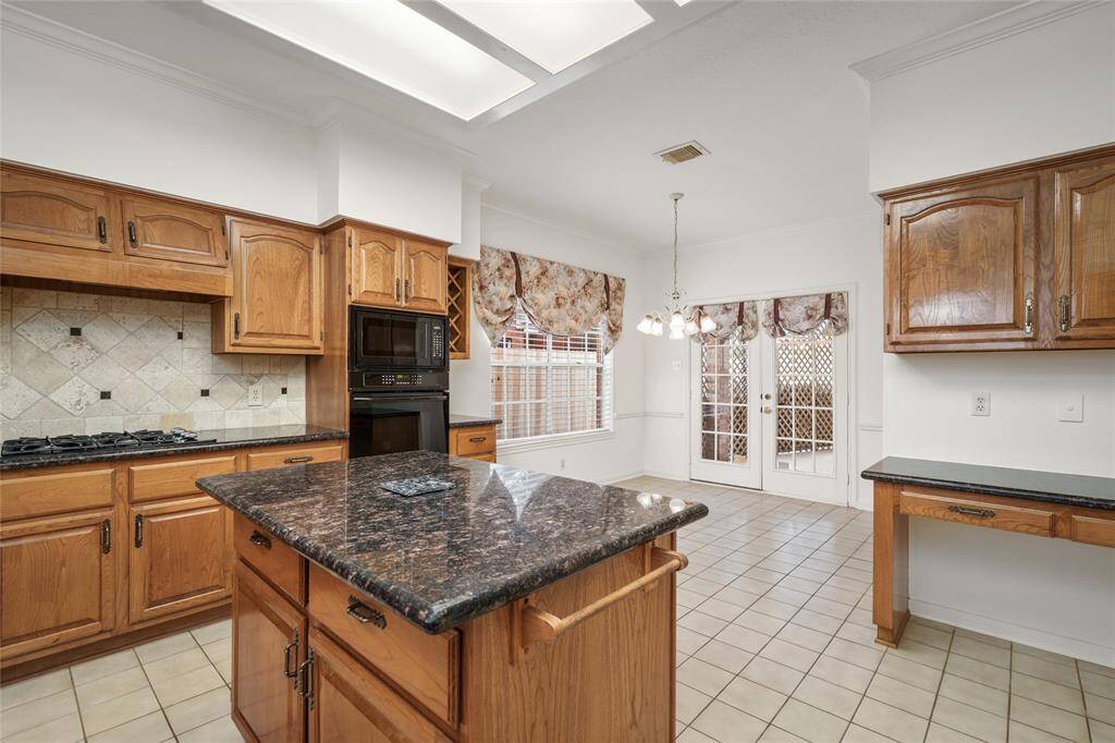 From this angle, the spacious center counter provides a seamless transition into the cozy breakfast area, creating an open and inviting flow between the kitchen and dining space. The breakfast area offers a perfect spot for casual meals or morning coffee, with plenty of room to gather around. The layout allows for easy interaction between the kitchen and breakfast area, making it an ideal space for both everyday meals and entertaining.
