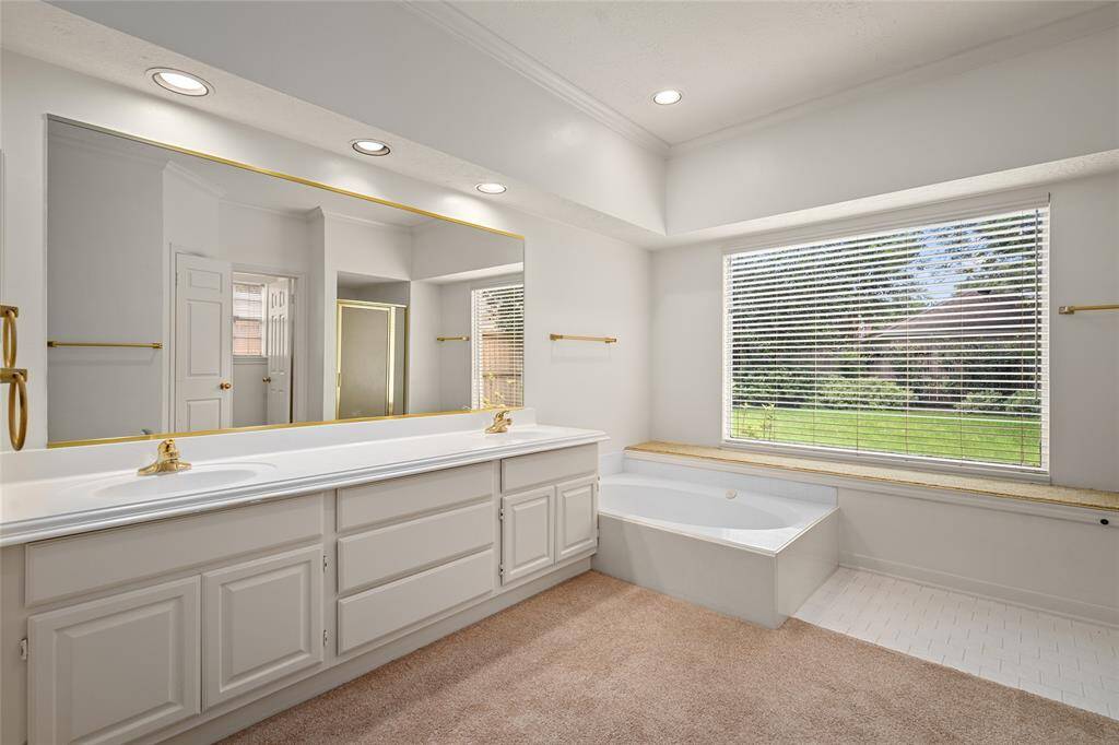 The primary bath offers a luxurious yet functional design with double sinks, providing ample space for both residents. A separate tub invites relaxation, while the separate shower adds convenience for busy mornings. The thoughtful layout ensures both comfort and privacy, creating a tranquil space to unwind and refresh.