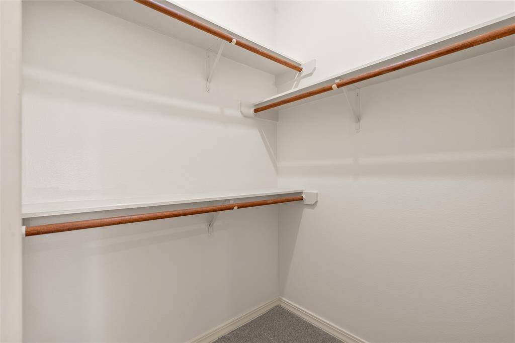 Adjacent to the bath, a spacious walk-in closet provides plenty of room for your wardrobe, ensuring easy organization and quick access to your essentials.