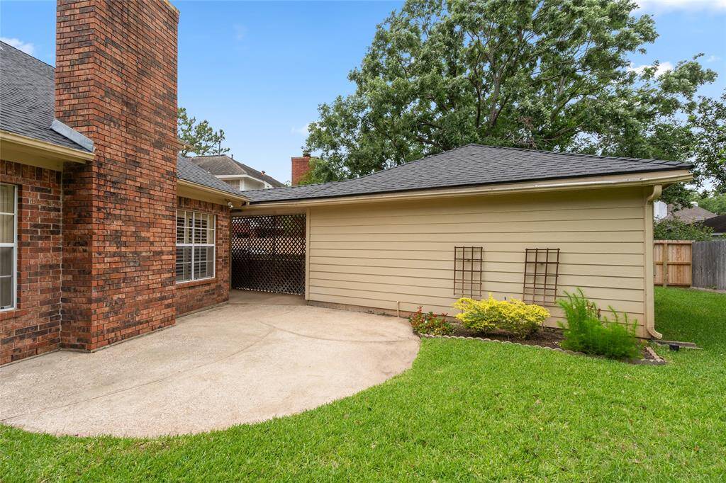 Another view of the backyard looking toward the detached garage. Set up your garden furniture or a cozy sitting area and enjoy sunny days outdoors—or unwind in the evening breeze for a peaceful end to your day.