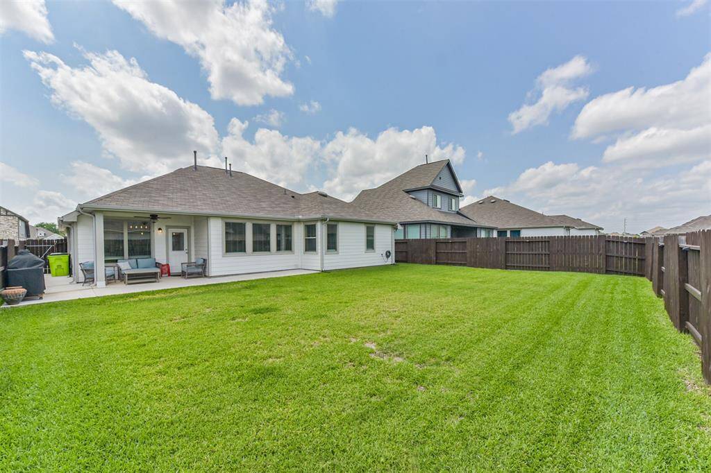 The sprawling backyard is easy to maintain with a full irrigation system already installed.