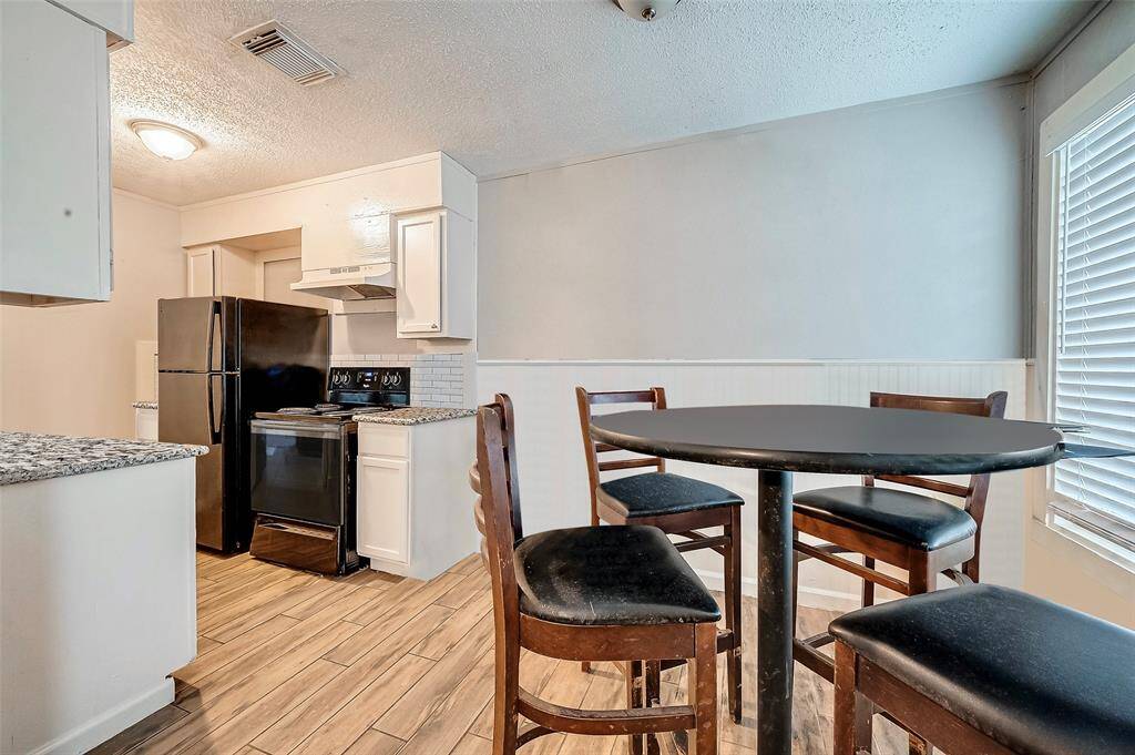 A view of the dining room looking into the kitchen