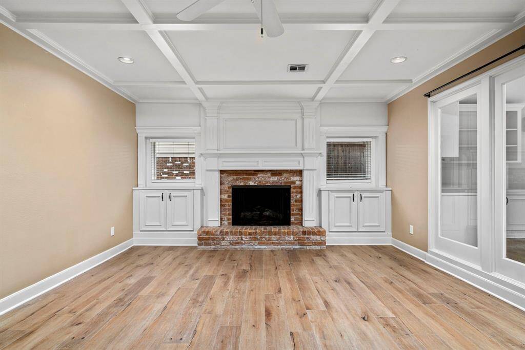 Large family room 24x14 has a fireplace with a raised hearth and built-ins.