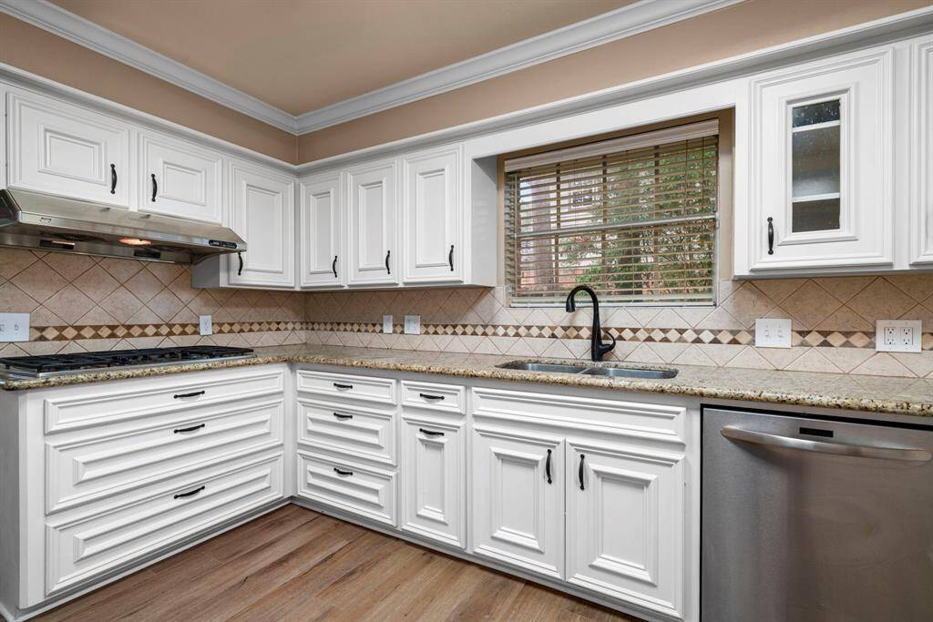 Kitchen features stainless appliances, remodeled cabinets.