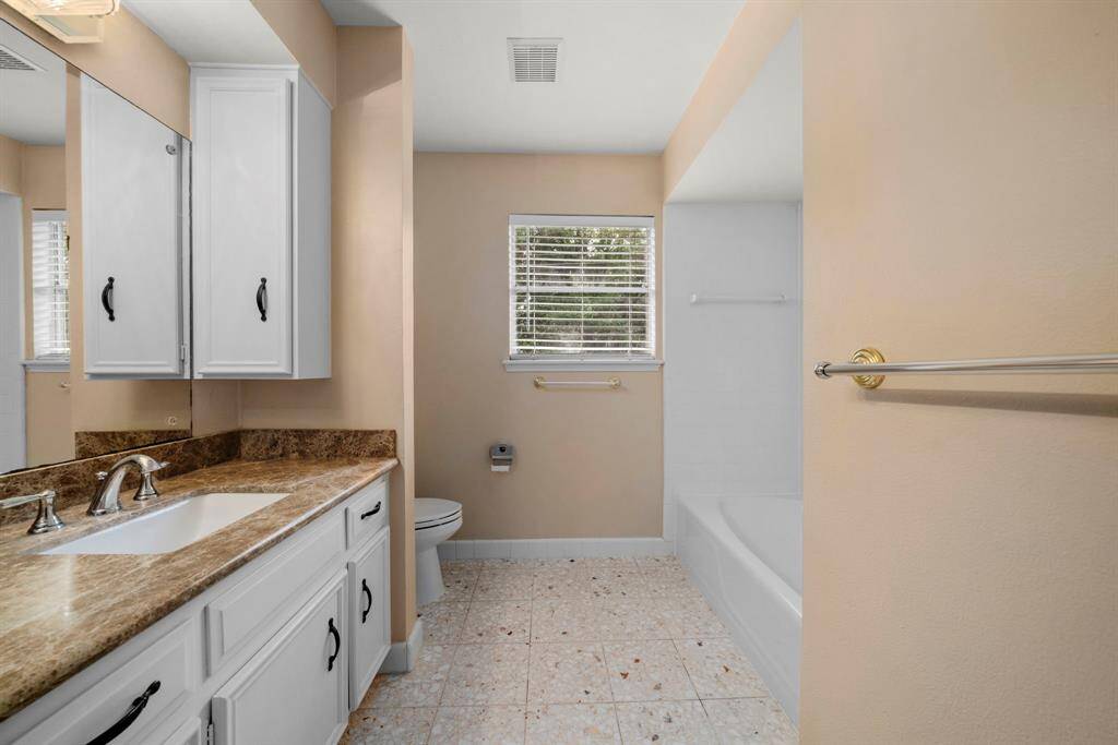 Hall bath has granite counters, double sinks, combo tub/shower