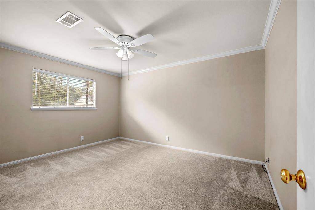 Secondary bedroom #2 up has newer carpet, neutral paint, crown molding.