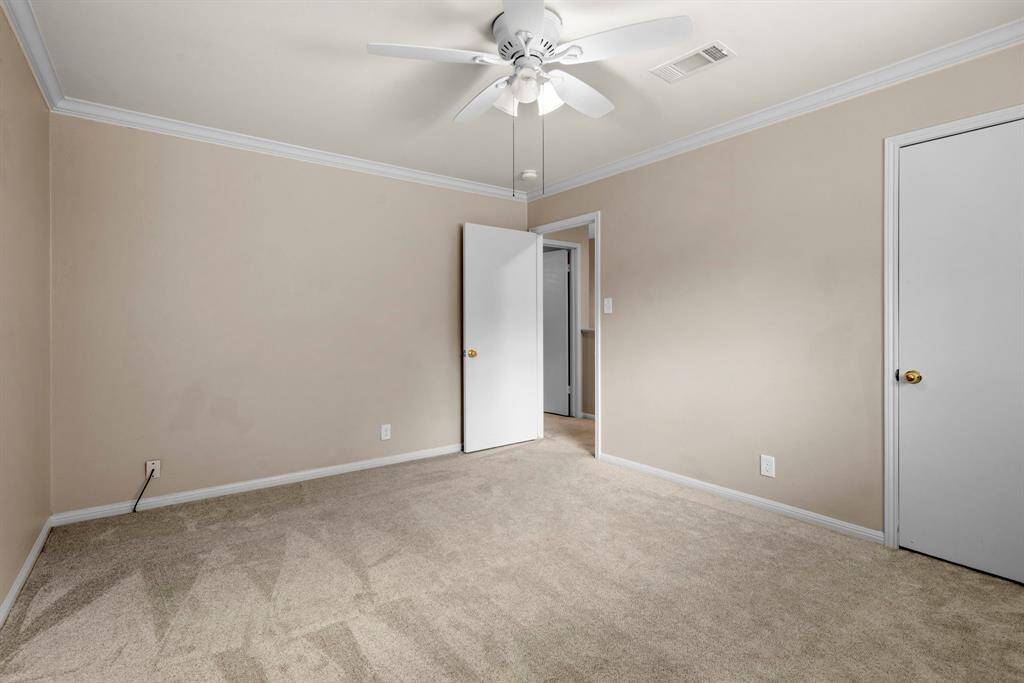 Secondary bedroom #2 up has newer carpet, neutral paint, crown molding.