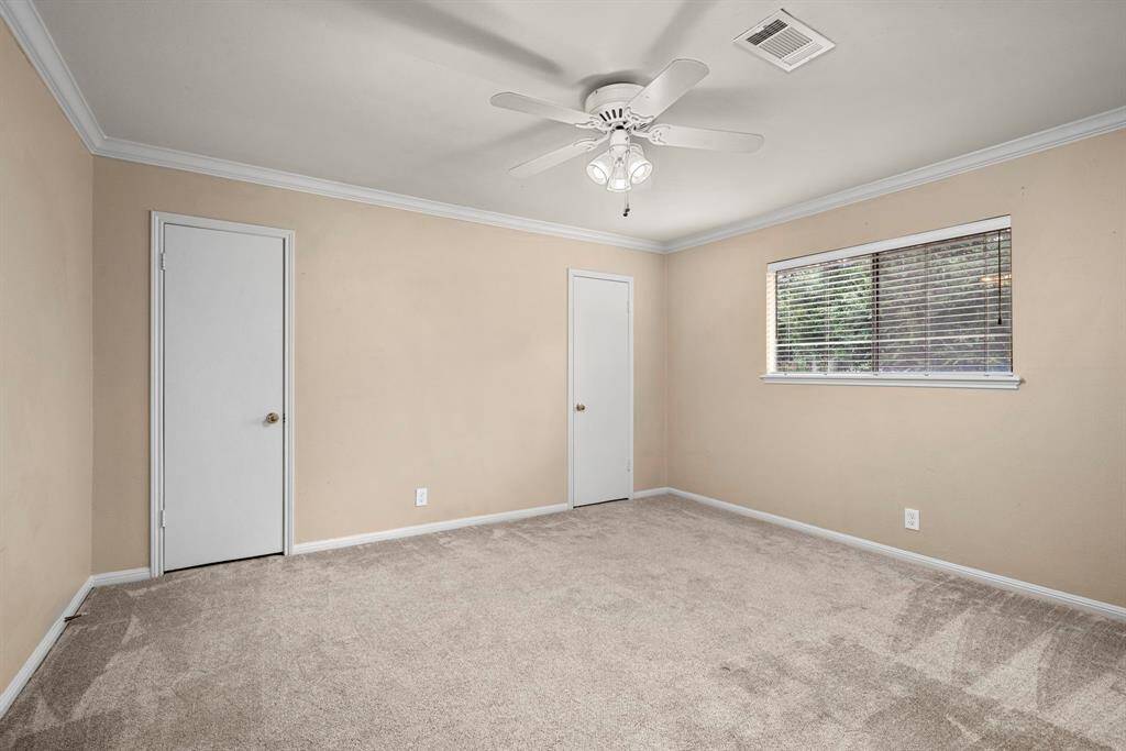 Secondary bedroom #3 up has newer carpet, neutral paint, crown molding.