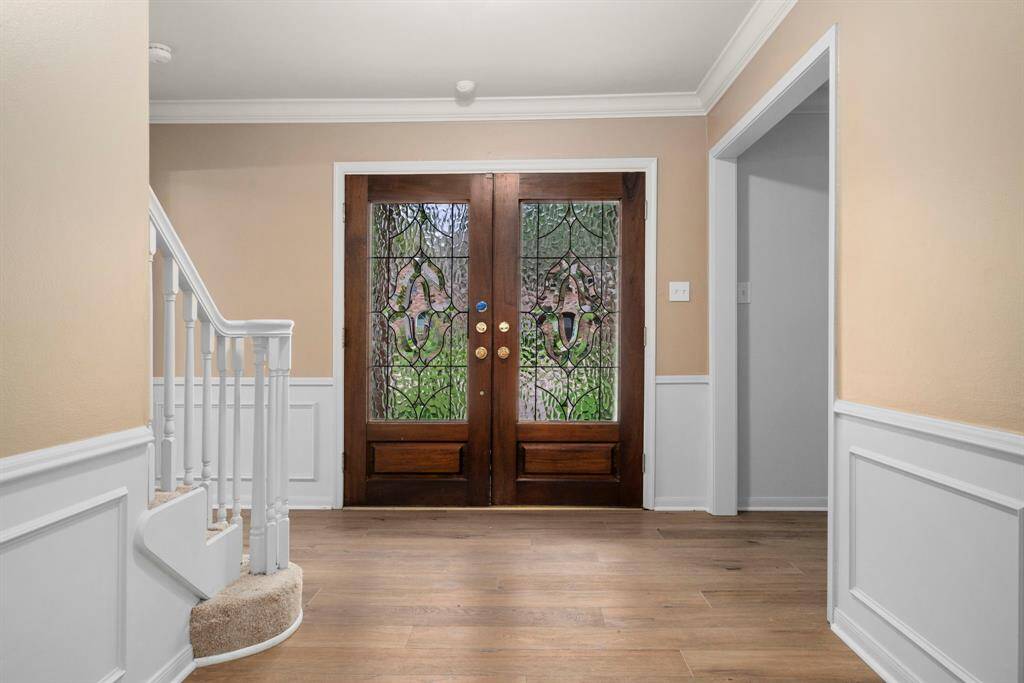 Beautiful double door entry with beveled glass shows off recent high quality luxury vinyl plan flooring throughout first floor.