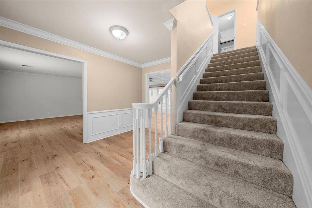 View into living room. Newer carpeted stairs shown.