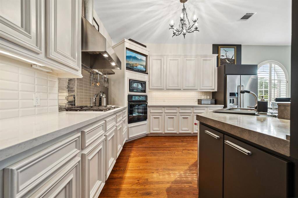 This chef’s kitchen is a culinary dream, featuring a stunning honed limestone island with bar seating, perfect for casual meals or socializing while cooking