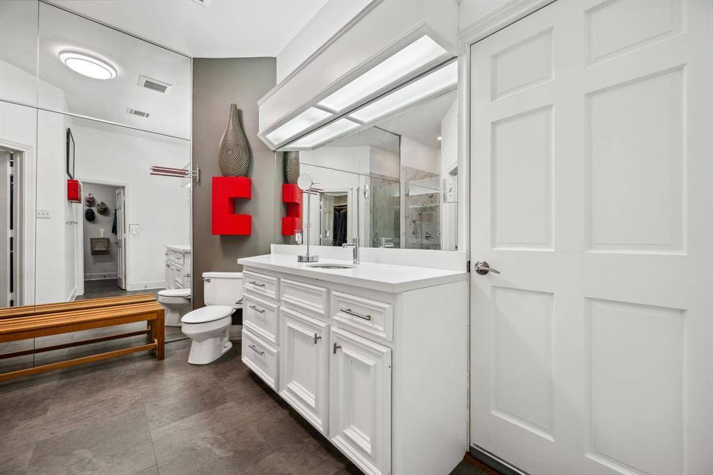 This luxurious glass-enclosed shower features unique pebble floors, adding a natural touch to the elegant design. The modern fixture and sleek finish create a spa-like experience, making it the perfect spot for relaxation and rejuvenation.