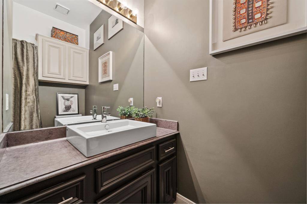 Currently serving as a functional work space, this room could easily be converted into a second bedroom. Located adjacent to the primary bedroom, it offers flexibility and convenience, perfect for a guest room, office, or additional living space.