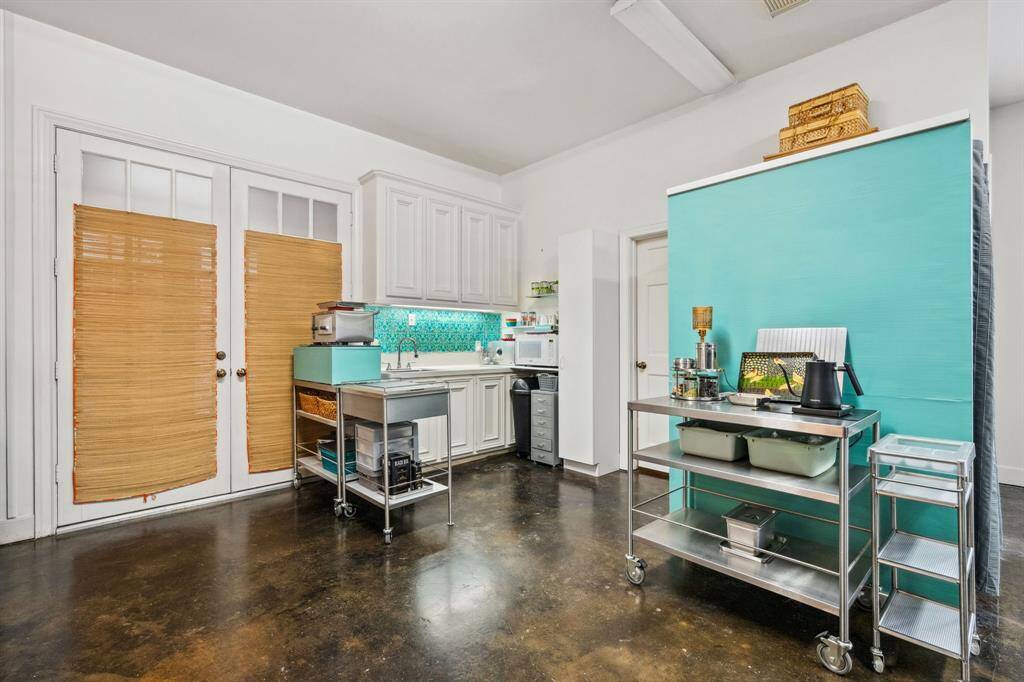 Located just off the downstairs entry, this flexible area can easily serve as an office, guest suite, or additional bedroom. Its adaptable design provides the perfect balance of privacy and convenience, making it ideal for a variety of uses.
