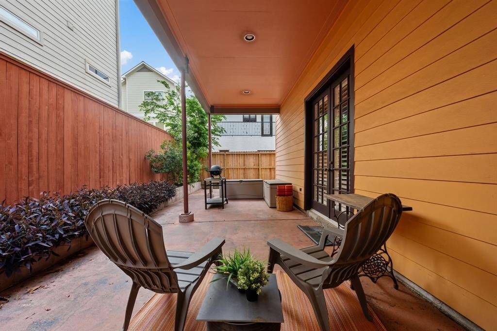Upstairs covered patio offers serene treetop views—an ideal spot to unwind or enjoy al fresco dining in a peaceful setting
