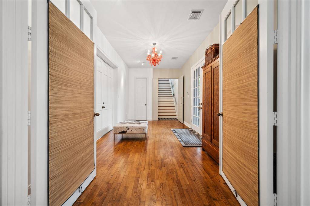 A warm welcome awaits at this home's sophisticated front entry, featuring stunning double glass doors that bring in natural light.