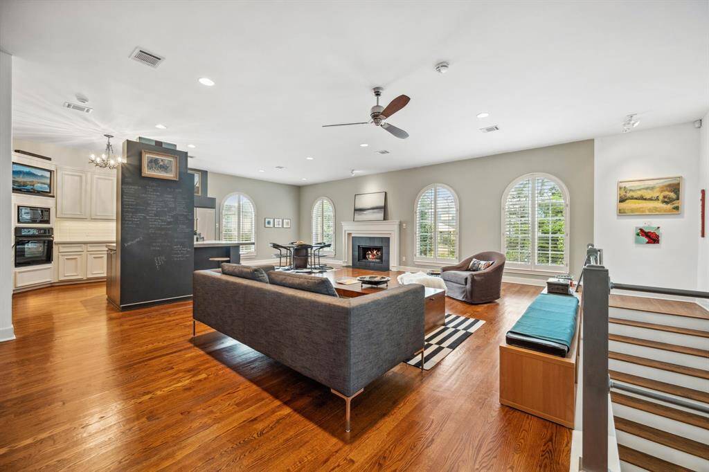 Another view showcases the open-concept design, where the spacious living room effortlessly connects to the kitchen, dining area, and adjacent office space. Perfect for both everyday living and entertaining, this layout enhances natural light and promotes easy movement throughout the upper level.