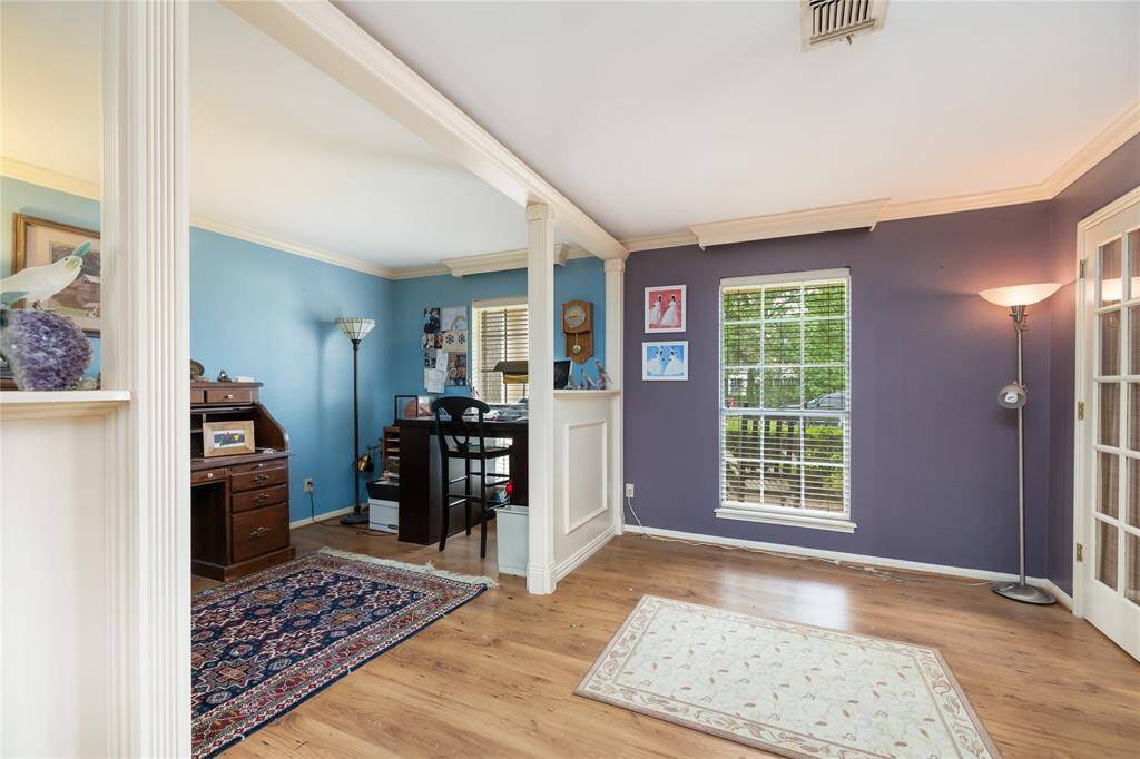 This spacious home office is thoughtfully designed with a partial wall and opening, creating two distinct areas while maintaining an open feel. Whether for creative pursuits, focused work, or study, this flexible space offers endless possibilities to suit your needs.