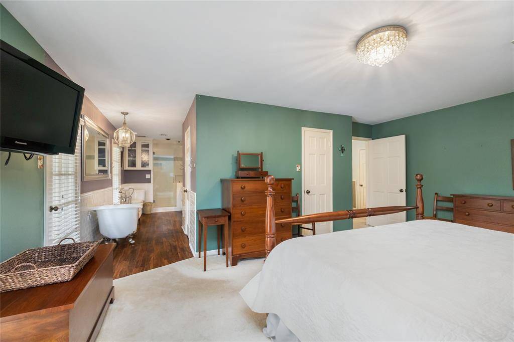 The primary bedroom effortlessly flows into the bathroom, where grandeur awaits. This open transition sets the stage for a spa-like experience, combining elegance and comfort in a space designed for ultimate relaxation.