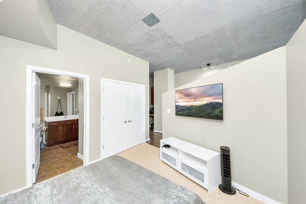 View from the bedroom showcasing a seamlessly connected bathroom and spacious closet, offering both functionality and comfort in one cozy space!
