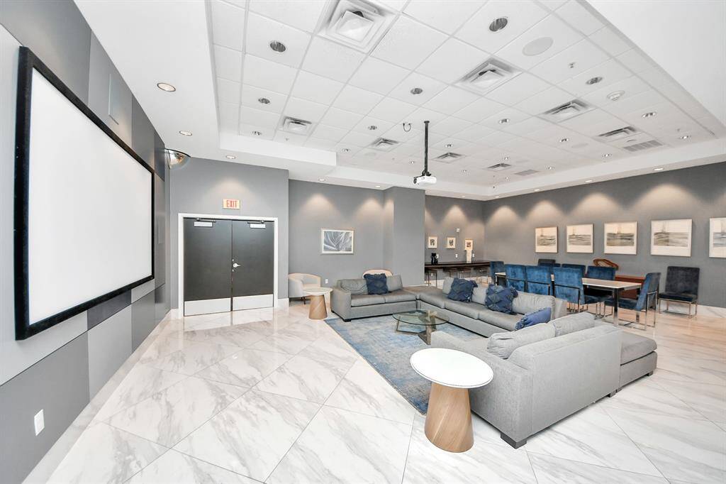 Relax in the spacious media room on the first floor, complete with a large screen, cozy couch, and coffee table—perfect for movie nights or entertaining guests in style!