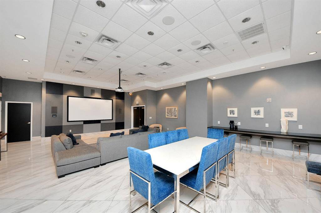 Another view of the media room, featuring a large screen, comfortable seating, and a cozy atmosphere—ideal for unwinding or hosting friends!