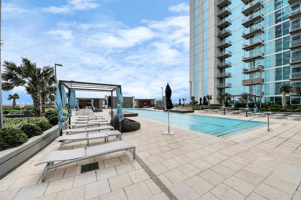 Enjoy a different angle of the pool, featuring cozy cabanas, lounge chairs, and daybeds—perfect for relaxation and soaking up the sun!