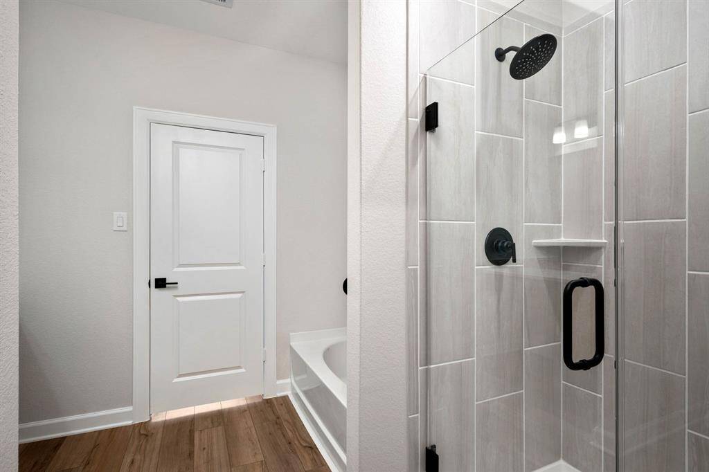 Imagine stepping into a spacious shower with upgraded fixtures. Beautiful!