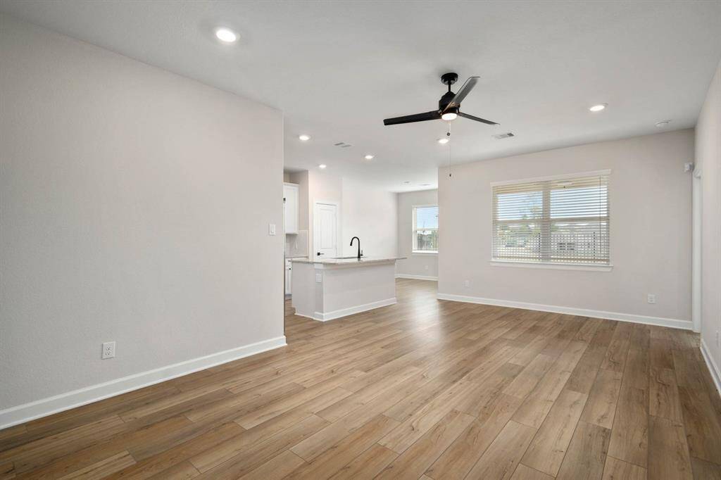 Look at the natural light and gorgeous vinyl plank floors in the living room.