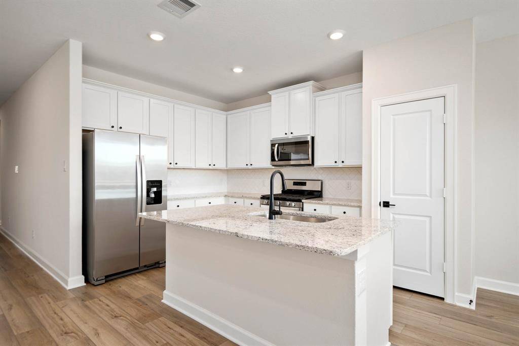 This breakfast bar will perfectly fit barstools for entertaining and socializing.
