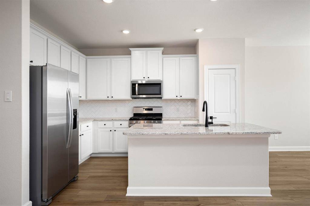 The kitchen cabinets are upgraded and painted, and the appliances are brand new, stainless steel, Whirlpool appliances.
