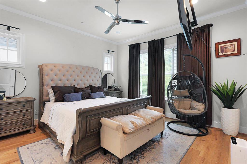 Retreat to the comfort of the primary suite, a serene haven designed for rest, luxury, and privacy. This expansive room is bathed in natural light from large windows, offering tranquil views and a sense of retreat from the rest of the home. High ceilings, elegant crown molding, and soft, neutral finishes create a calming atmosphere.